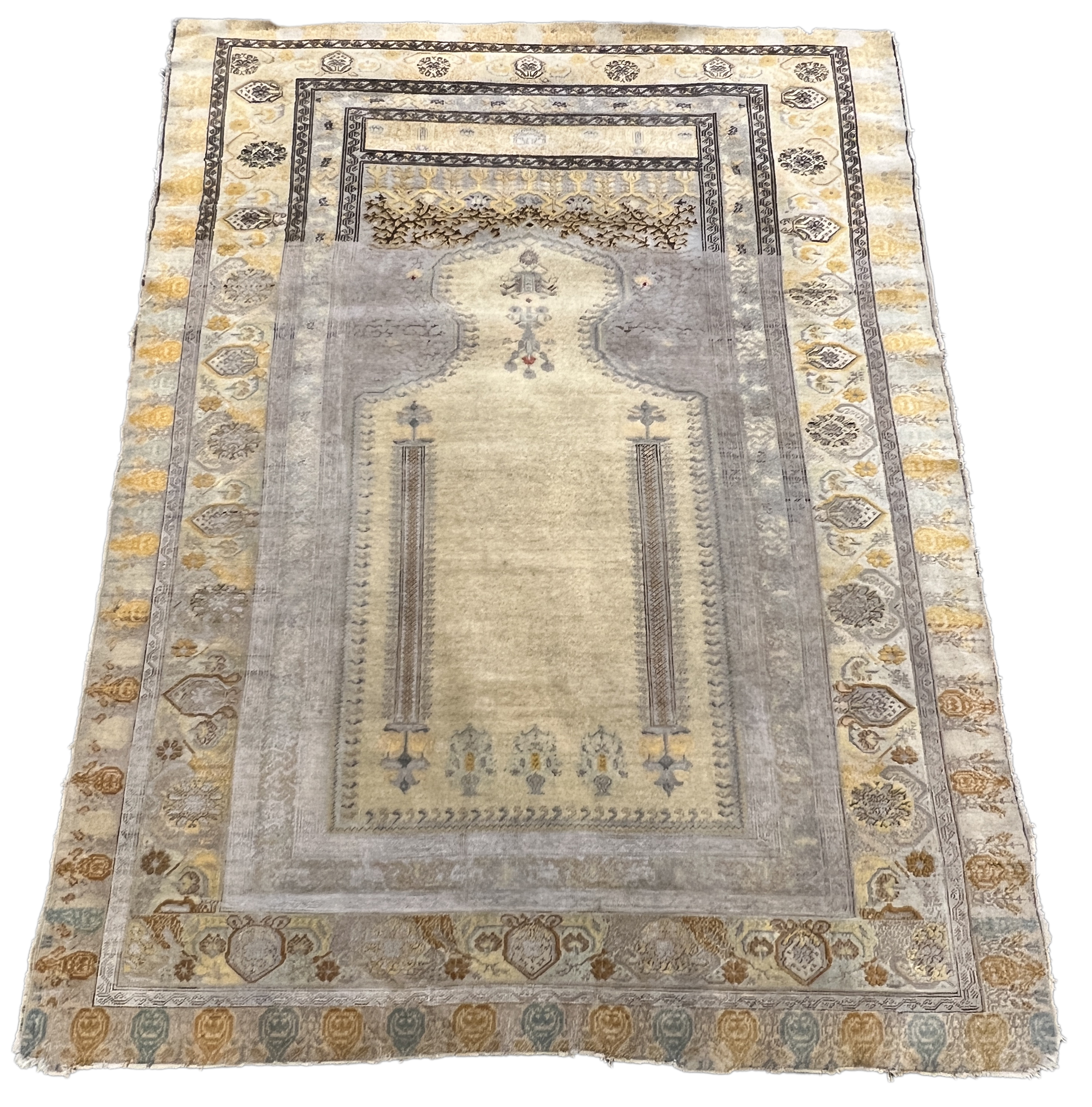 A Turkish silk prayer rug, with mihrab and stylised foliate borders on a gold ground, 185 x 137cm. Condition - the central panel severely worn to the tip of the mirror, lower fringe worn with losses.